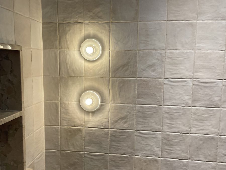 Tiled shower with wall sconces